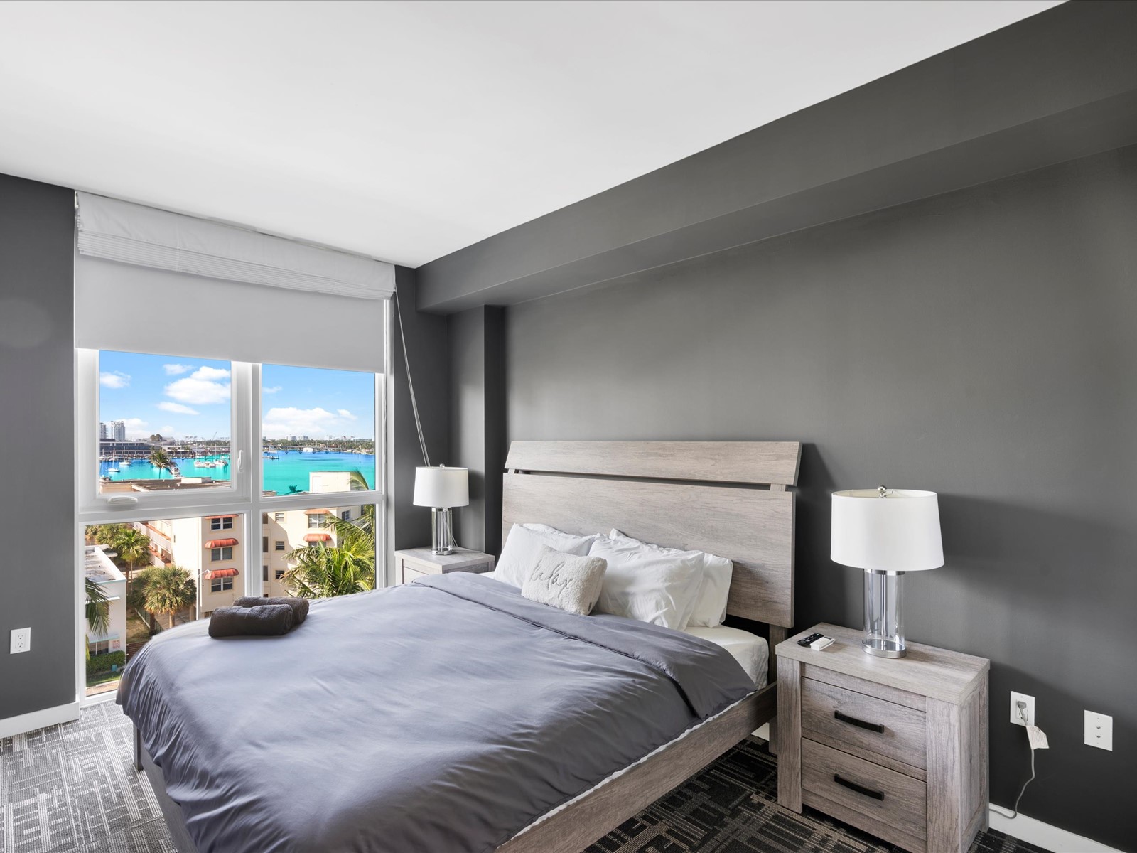 401 North Birch Road, Unit 603 Fort Lauderdale, FL 33304 - Photo 13 of 16 a bedroom with a bed and large windows