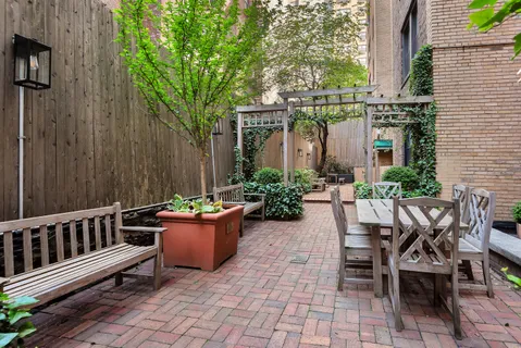 a view of a chair and tables in the patio