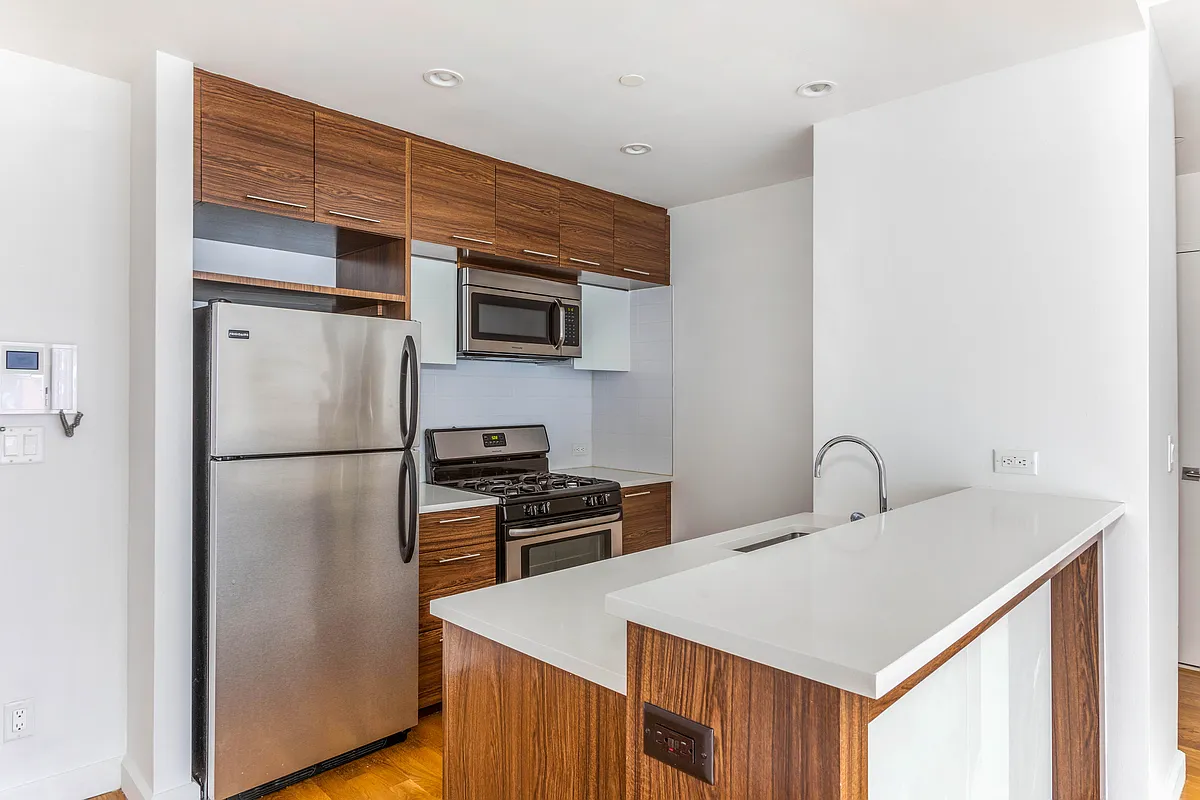 267 6th Street, Unit 3B Brooklyn, NY 11215 - Photo 2 of 15 a kitchen with stainless steel appliances a refrigerator and a stove