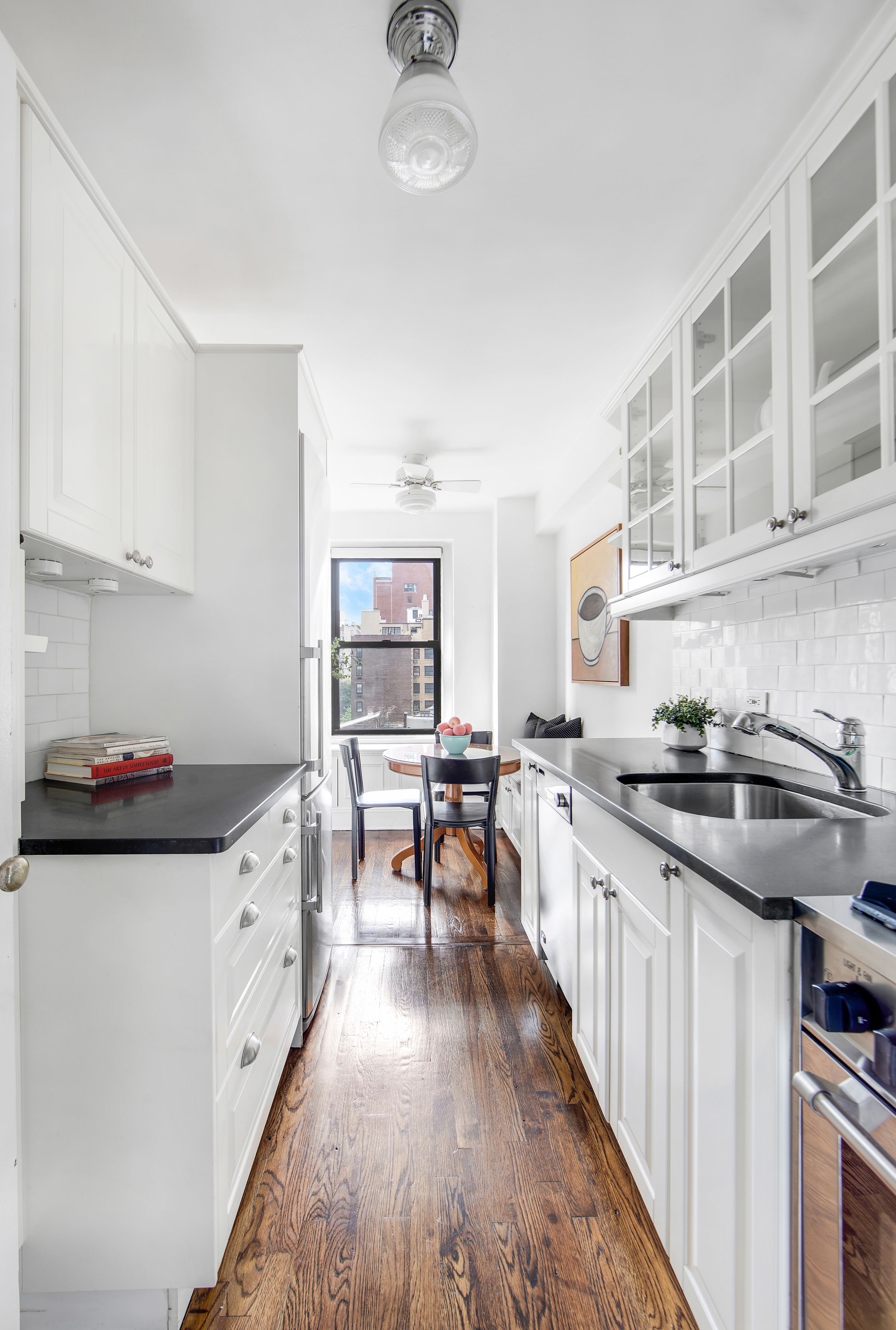 205 East 78th Street, Unit 9F Manhattan, NY 10075 - Photo 4 of 13 a kitchen with granite countertop a sink stove top oven and cabinets