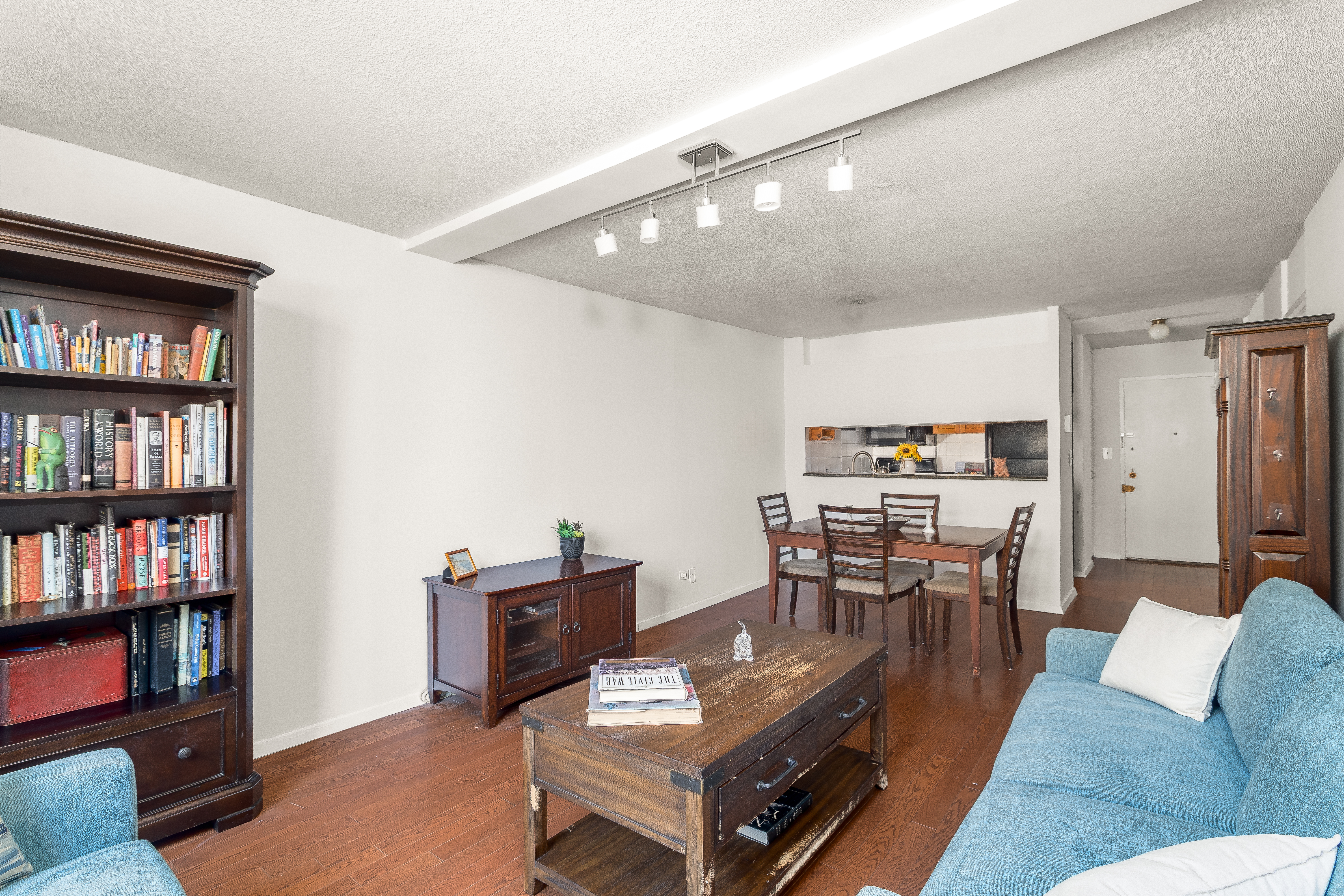 275 West 96th Street, Unit 12B Manhattan, NY 10025 - Photo 4 of 28 a living room with furniture and a book shelf