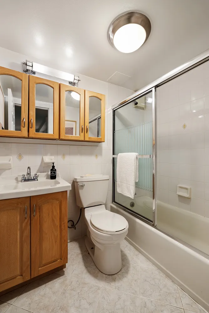 a bathroom with a toilet sink and mirror