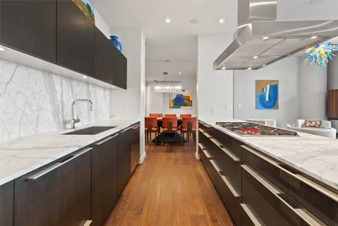 a large kitchen with stainless steel appliances a large counter top