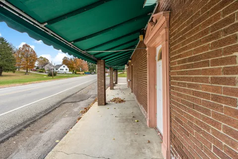 a view of a house with a patio and a yard