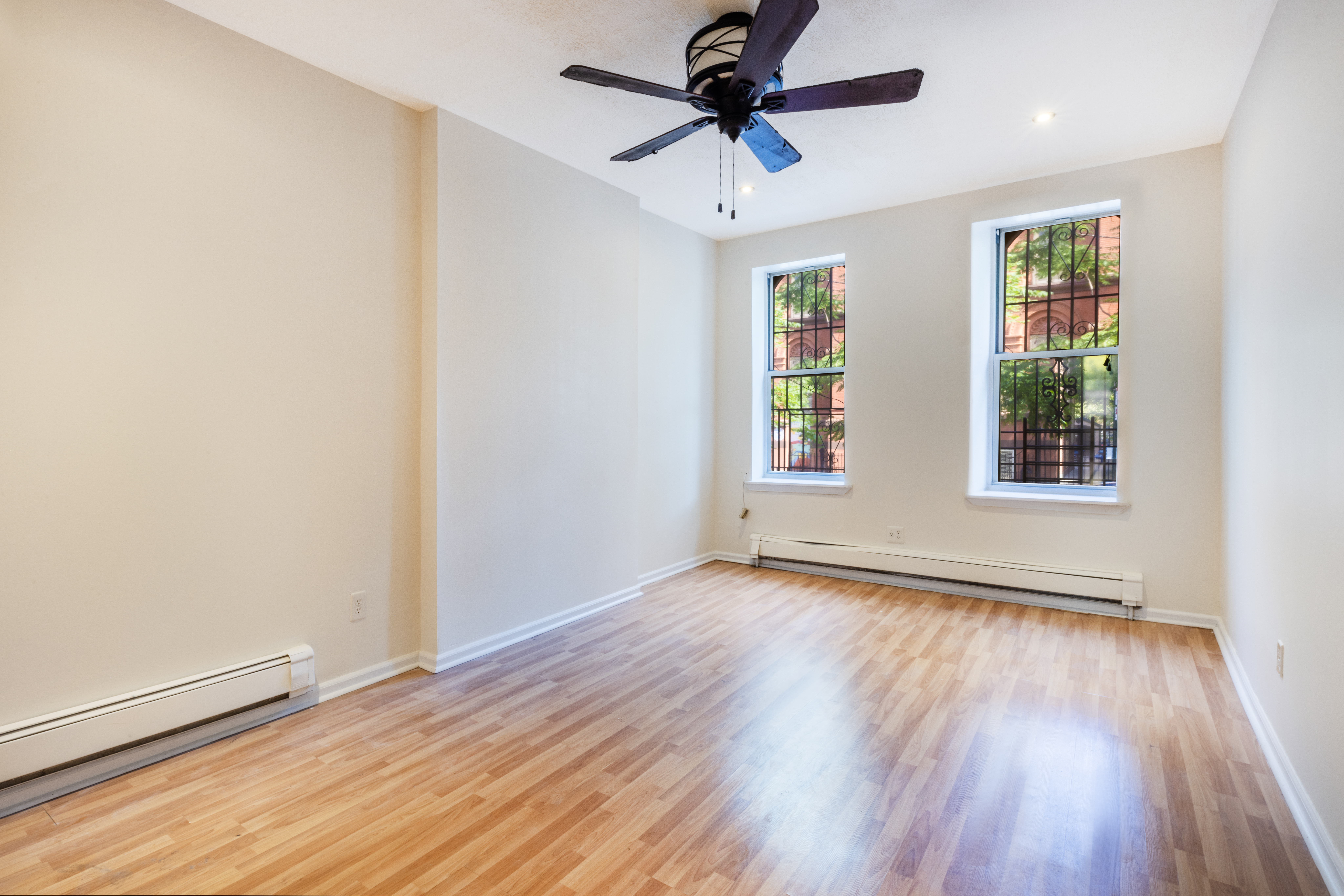 wooden floor in an empty room with a window