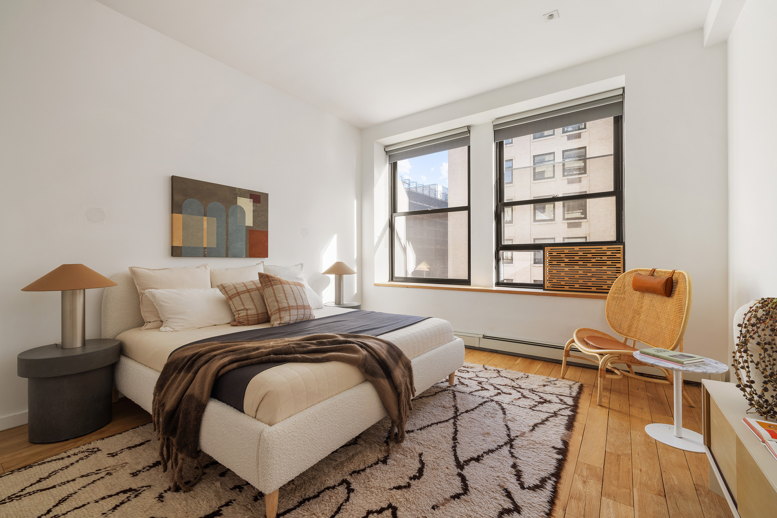250 Mercer Street, Unit B706B707 Manhattan, NY 10012 - Photo 16 of 25 a bedroom with a bed and wooden floor