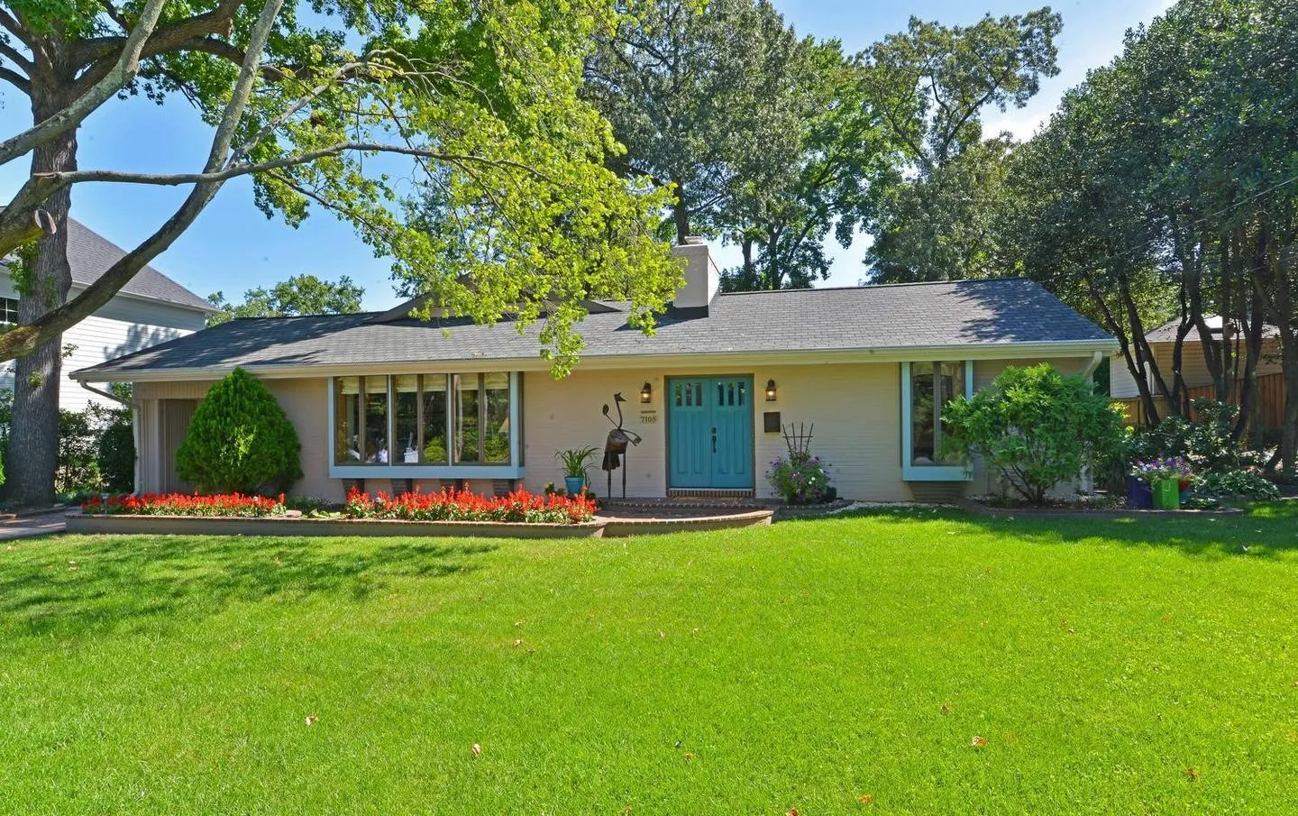 a front view of a house with a garden and porch