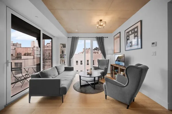 a living room with furniture and a large window