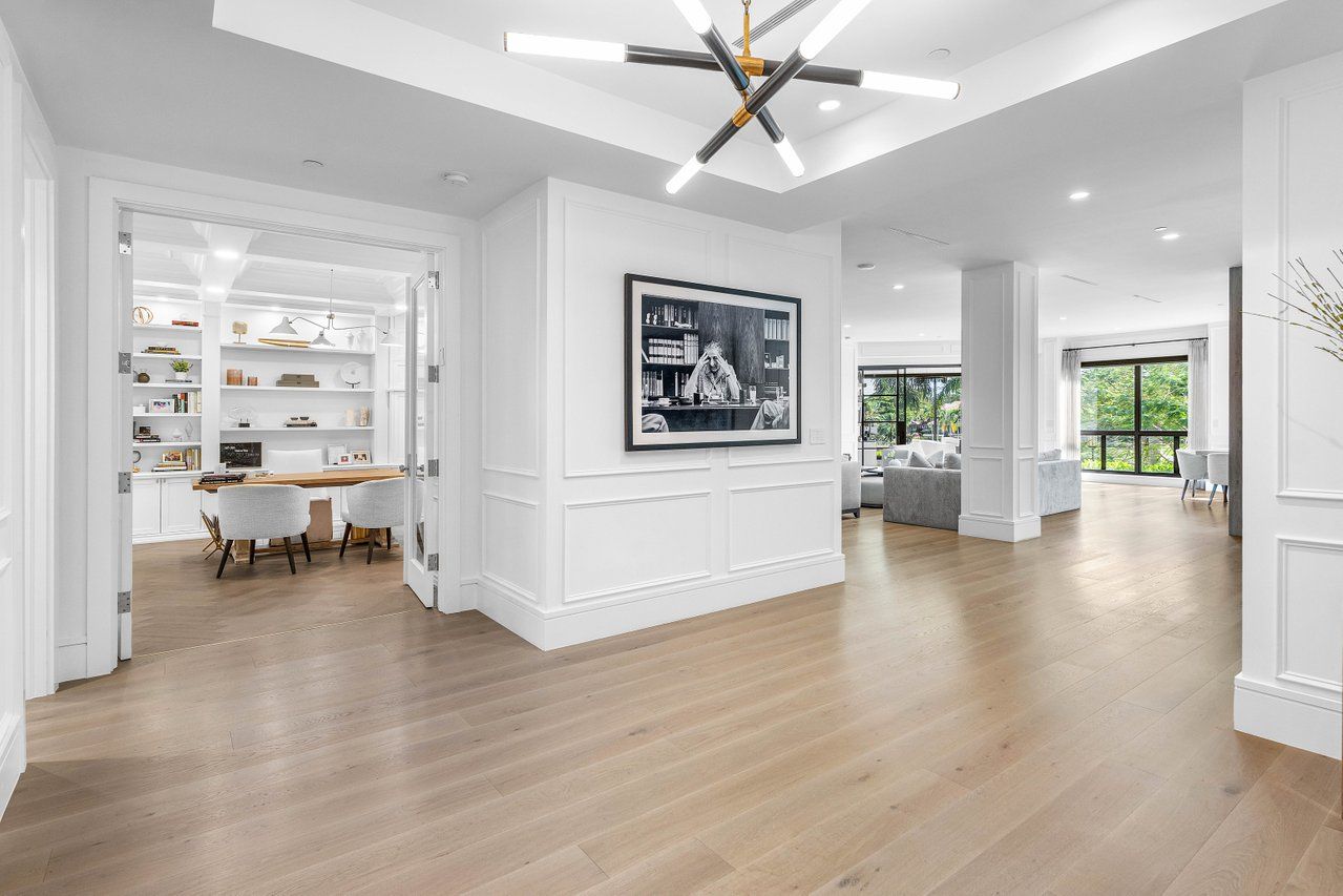 a view of a livingroom with furniture a ceiling fan and wooden floor