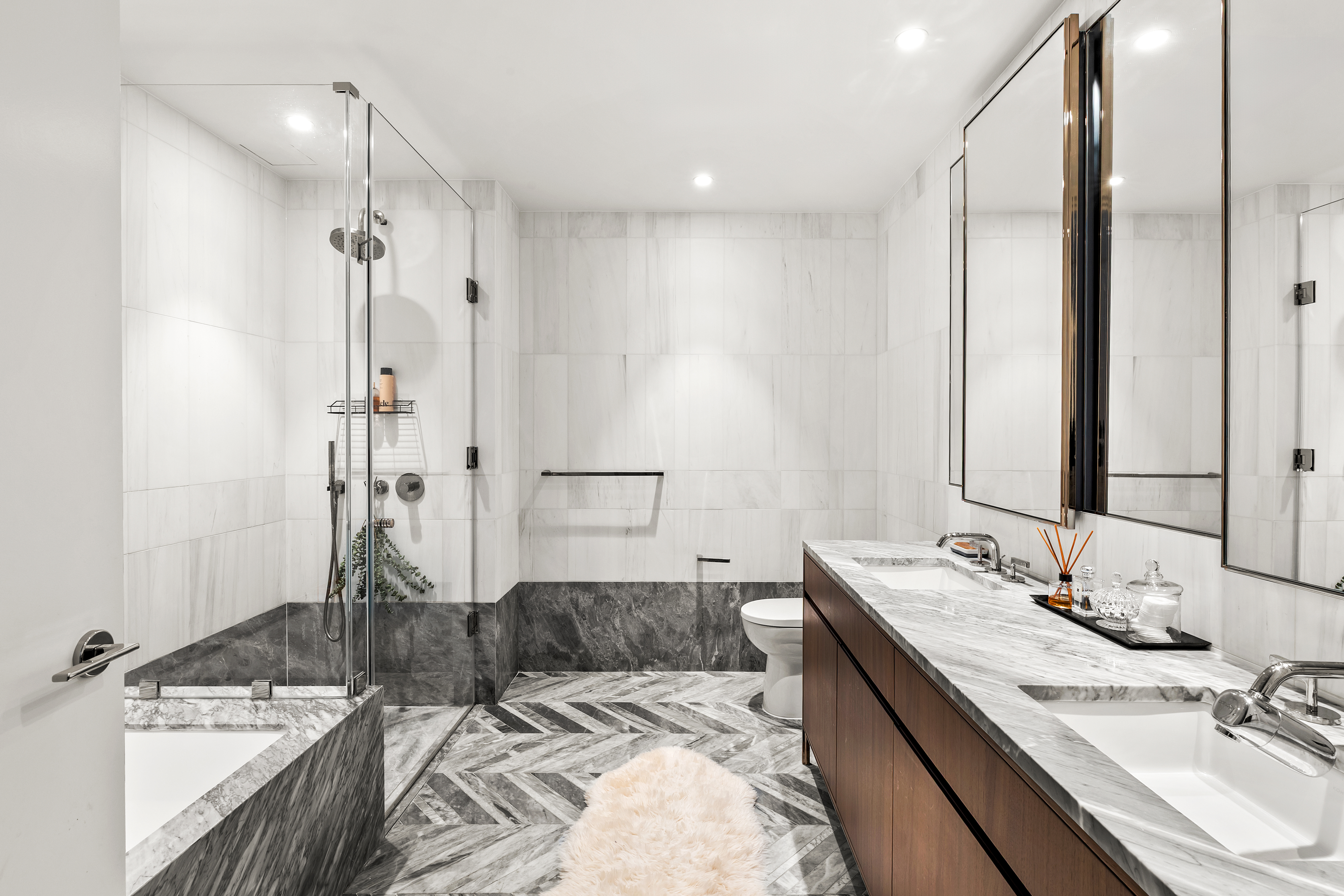 150 East 23rd Street, Unit 3C Manhattan, NY 10010 - Photo 5 of 12 a bathroom with a granite countertop sink and a mirror