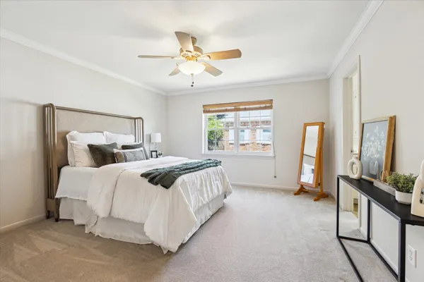 a bedroom with a bed flat screen tv and a window