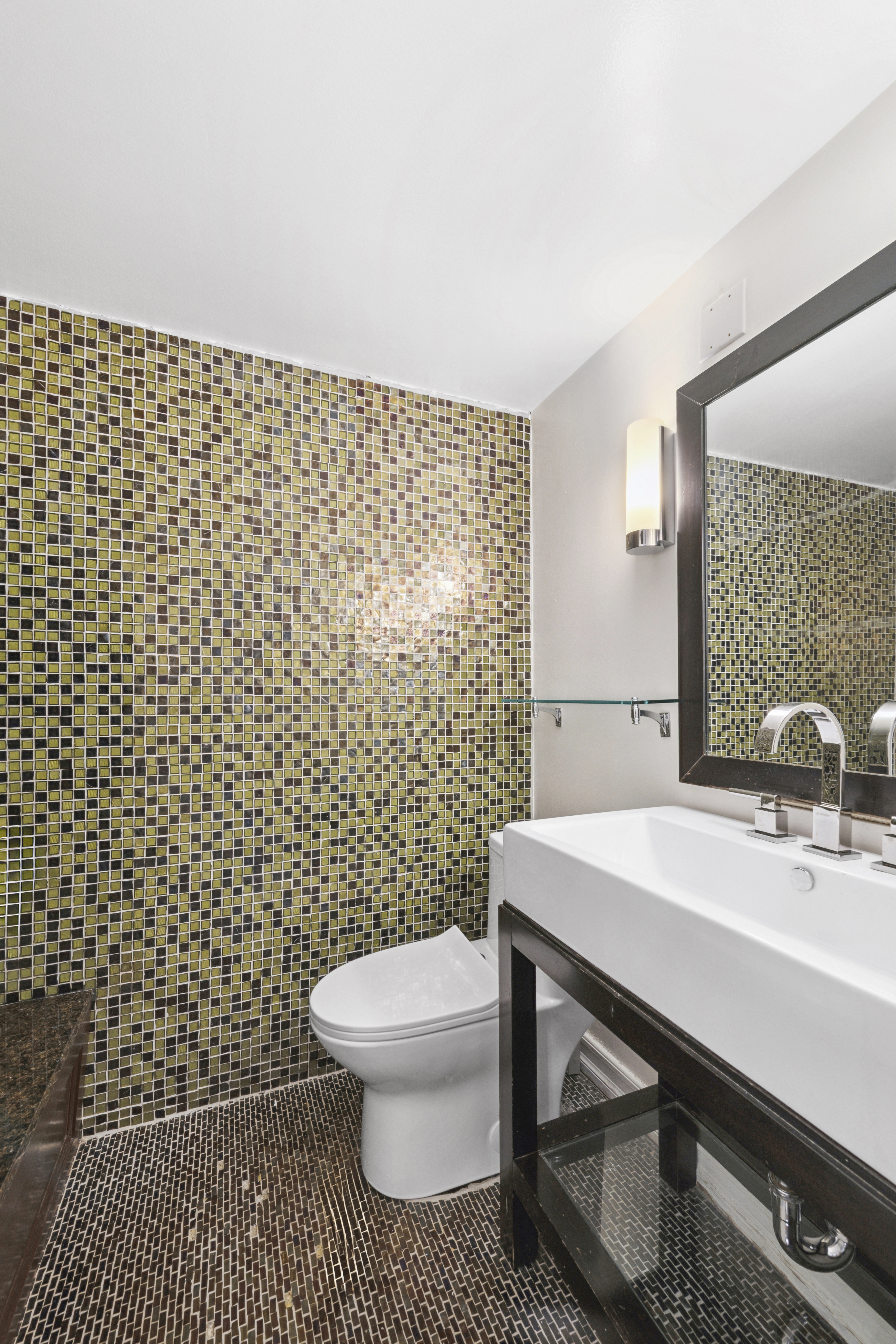 350 East 62nd Street, Unit 1N Manhattan, NY 10065 - Photo 8 of 8 a bathroom with a sink toilet and a mirror