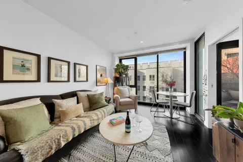 a living room with furniture and floor to ceiling windows