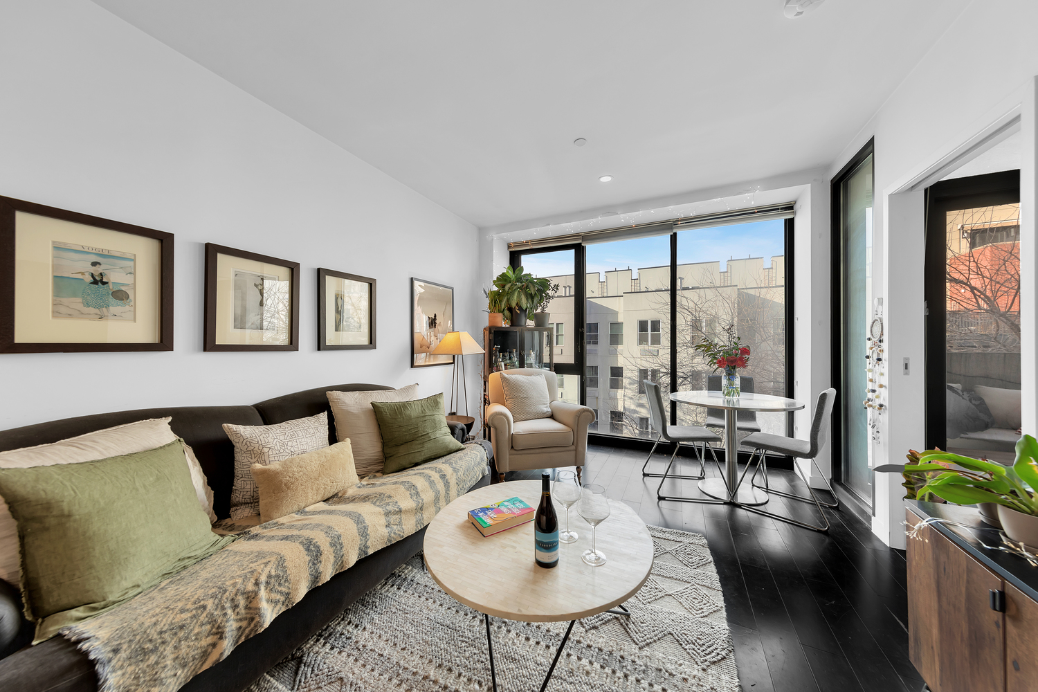 29 Montrose Avenue, Unit 4B Brooklyn, NY 11206 - Photo 2 of 6 a living room with furniture and floor to ceiling windows