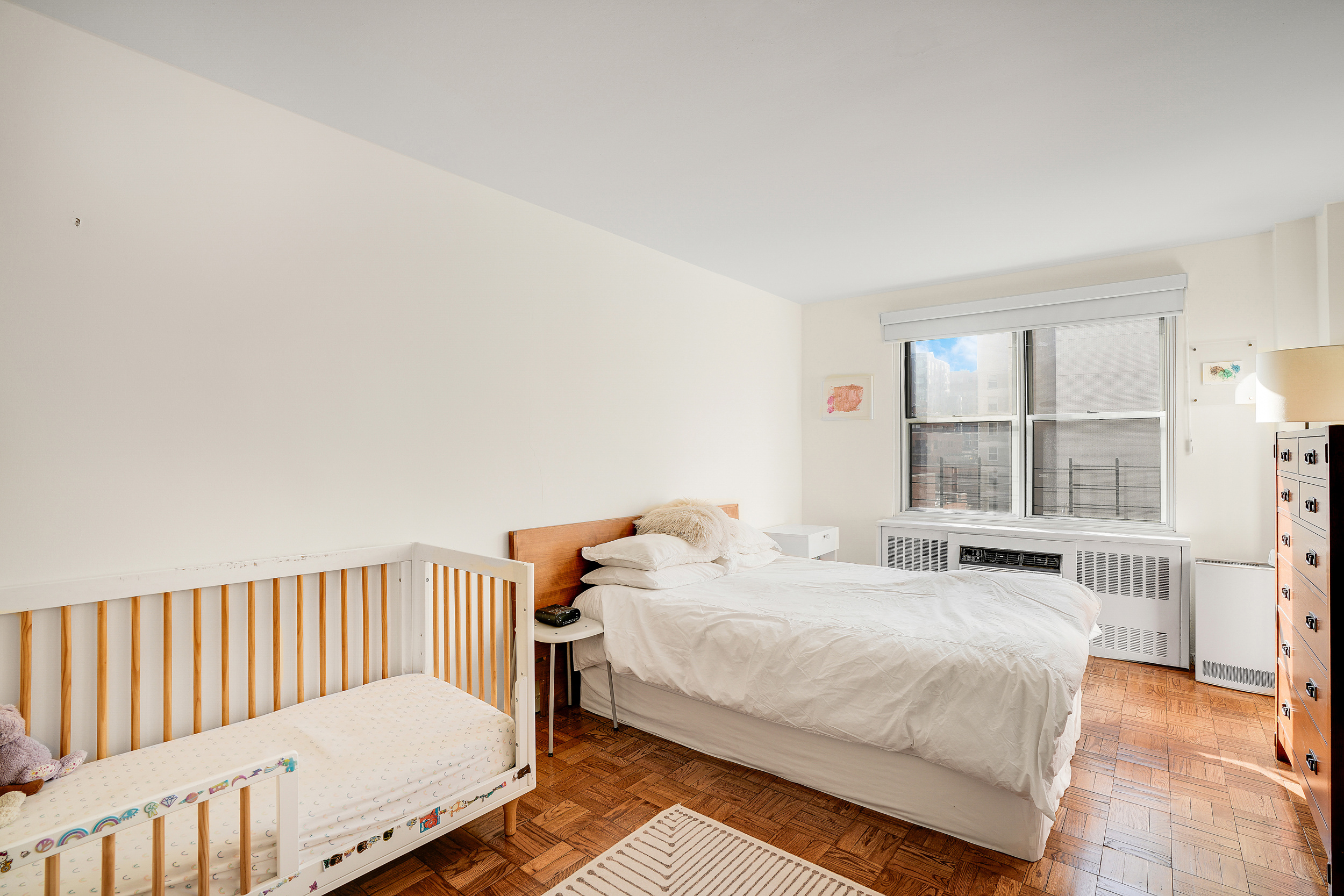 201 East 37th Street, Unit 11D Manhattan, NY 10016 - Photo 8 of 11 a bedroom with a bed and a large window with outer view