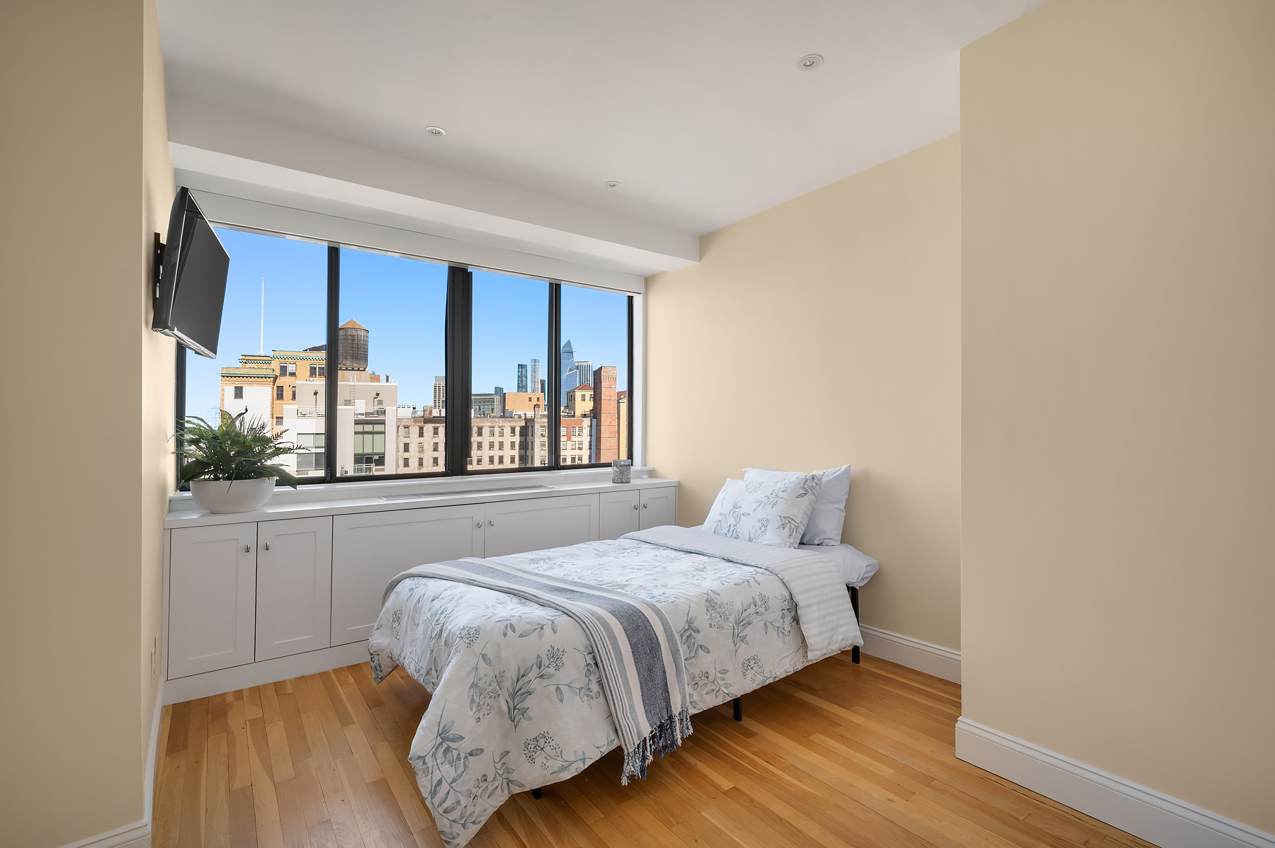 366 West 11th Street, Unit PHF Manhattan, NY 10014 - Photo 25 of 28 a bed sitting in a bedroom next to a window