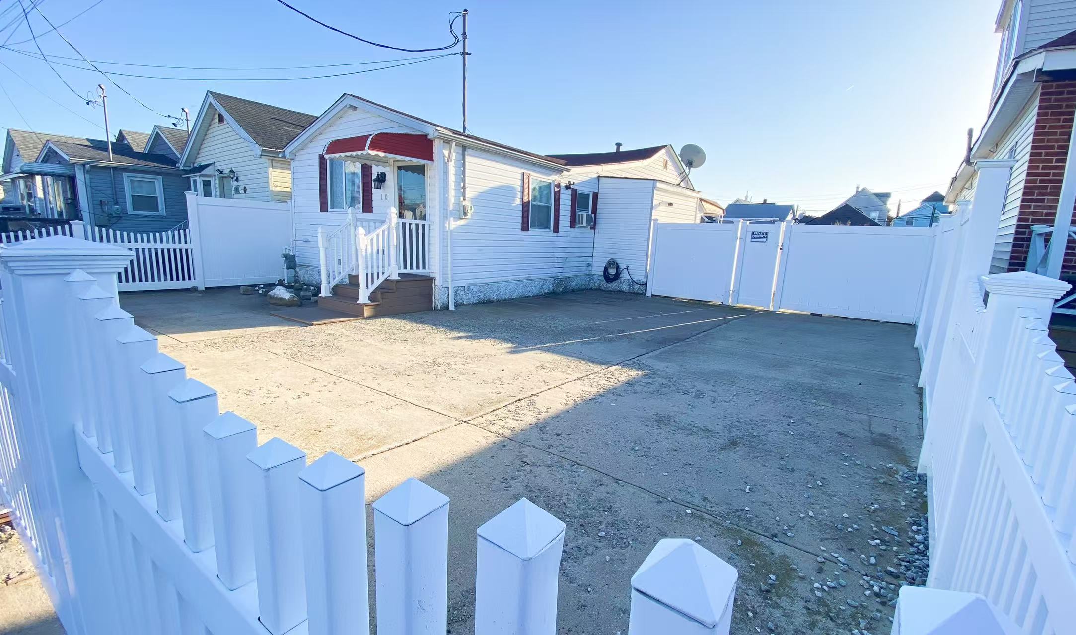 12 Church Street Queens, NY 11414 - Photo 2 of 2 a view of a house with a yard and wooden fence