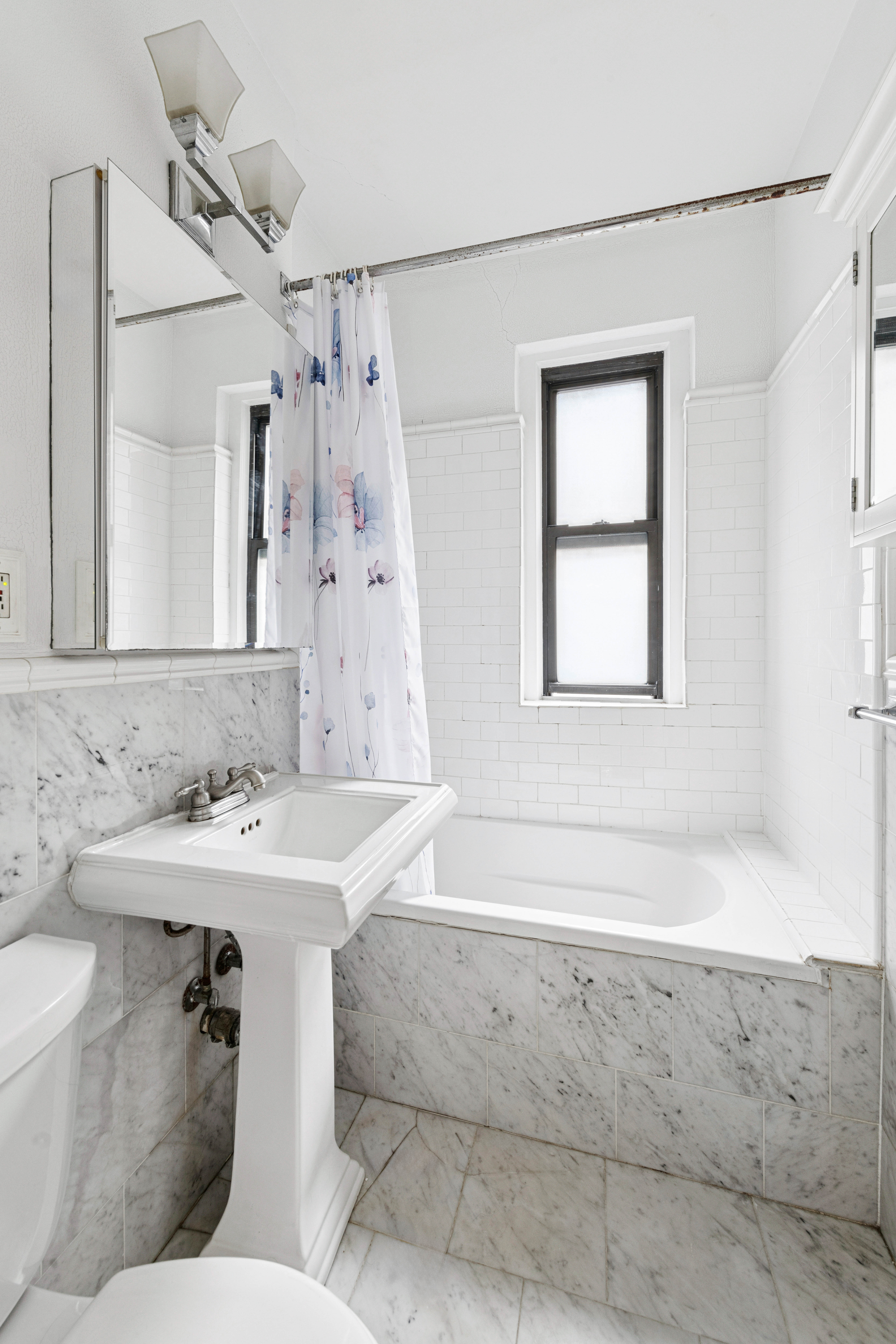 166 East 92nd Street, Unit 4C Manhattan, NY 10128 - Photo 5 of 6 a bathroom with a sink a toilet and shower