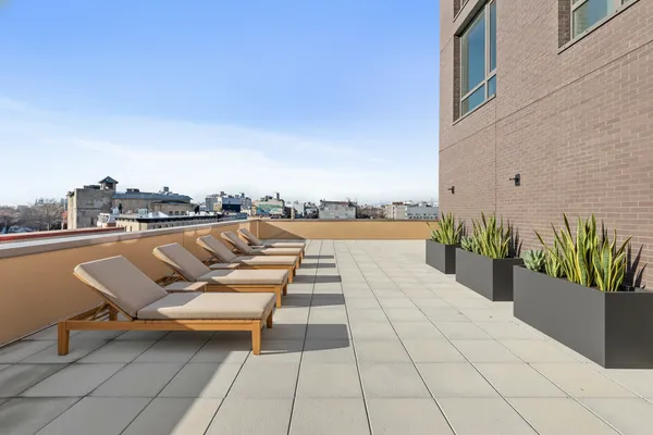 a view of swimming pool with outdoor seating and yard in the back