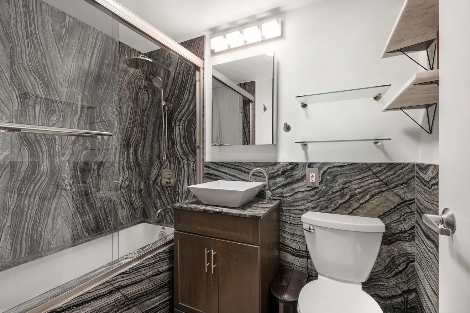 a bathroom with a sink toilet and shower