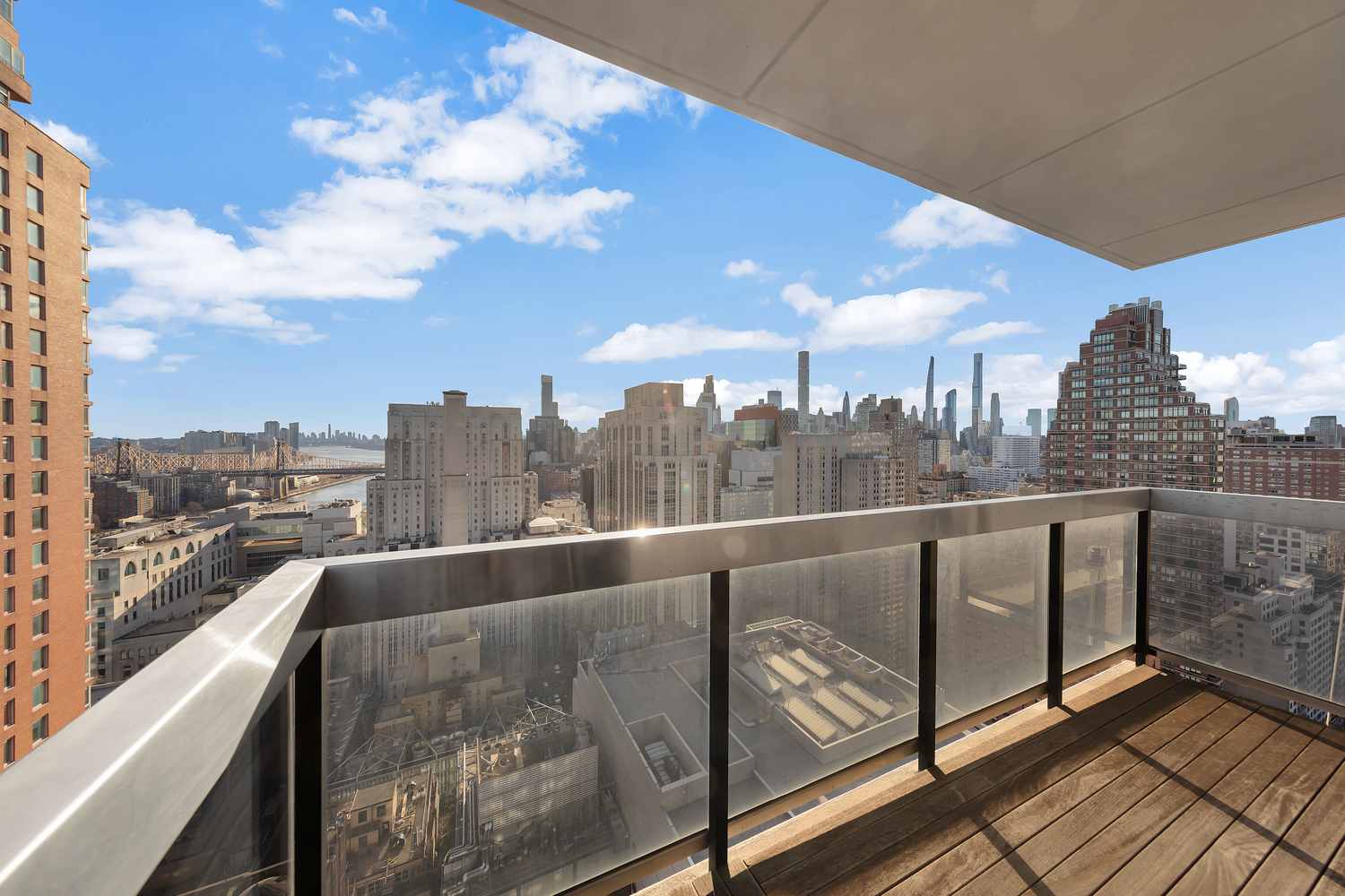 515 East 72nd Street, Unit 36B Manhattan, NY 10021 - Photo 5 of 36 a view of city from a balcony with furniture