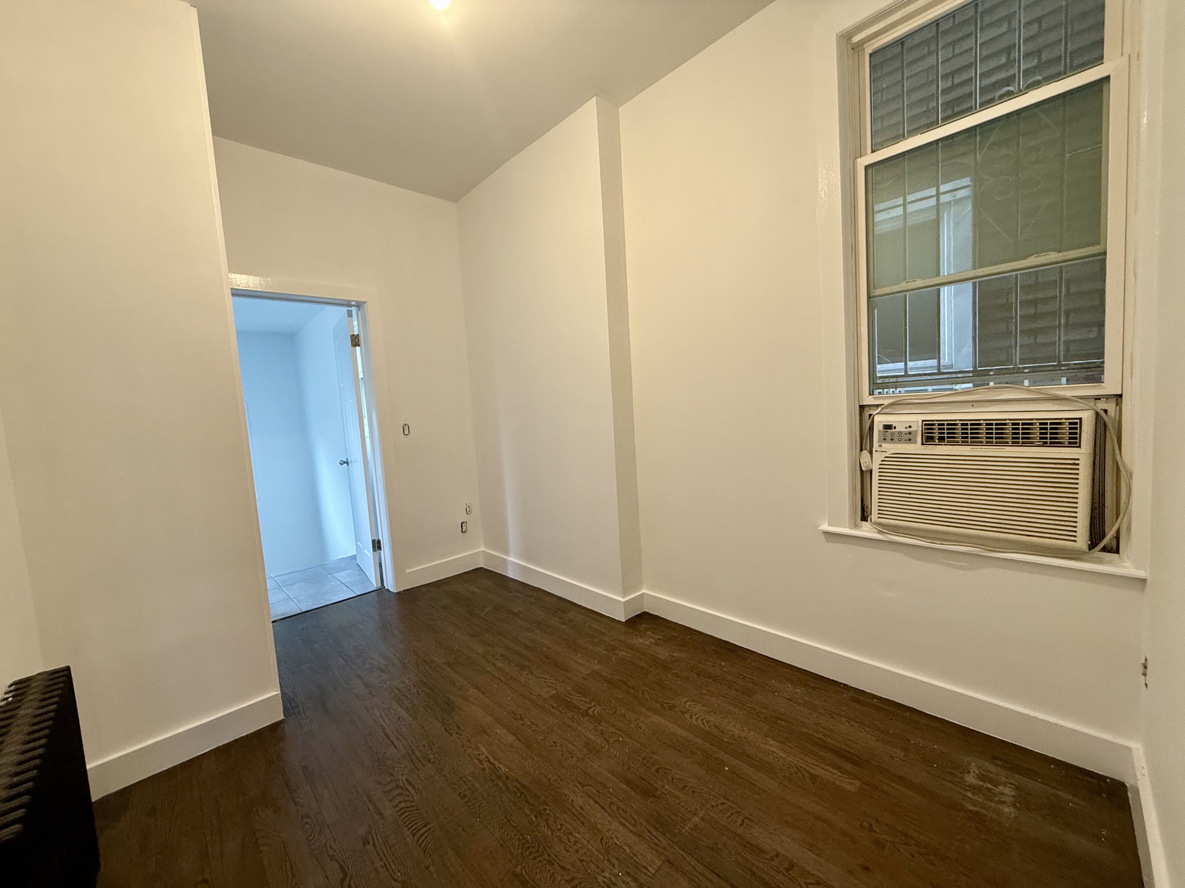 249 94th Street, Unit 1 Brooklyn, NY 11209 - Photo 6 of 13 an empty room with wooden floor and windows