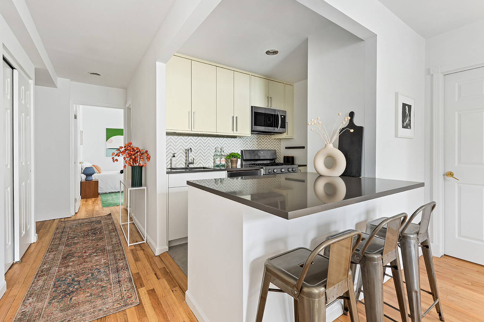 147 South Oxford Street, Unit 2C Brooklyn, NY 11217 - Photo 2 of 12 a very nice looking dining room with kitchen island furniture a sink a rug and a window