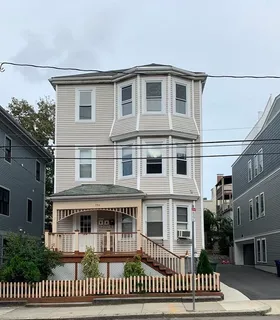 a front view of a house with a fence