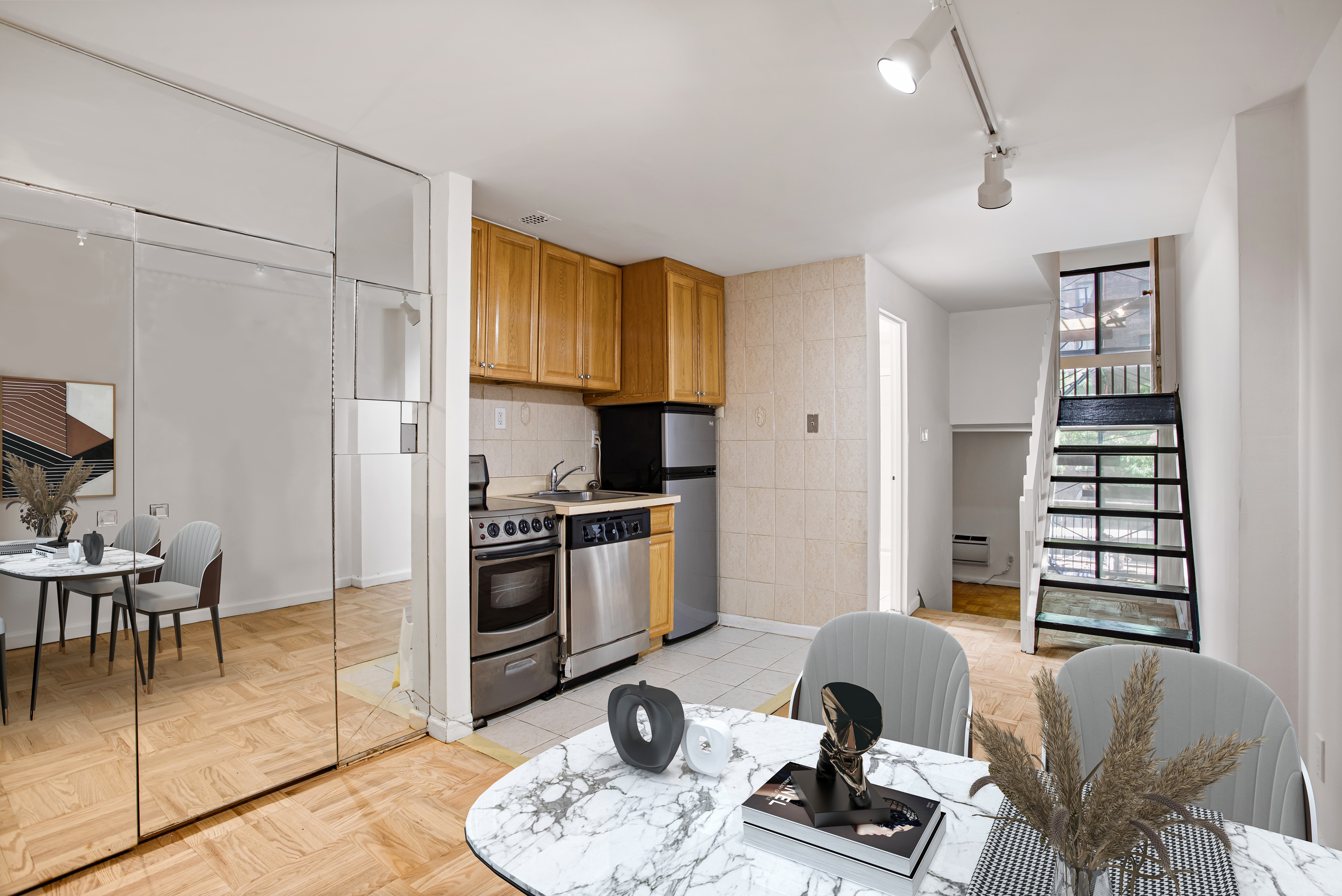 435 East 86th Street, Unit 2C Manhattan, NY 10028 - Photo 3 of 10 a kitchen with stainless steel appliances granite countertop a stove a refrigerator a dining table and chairs with wooden floor