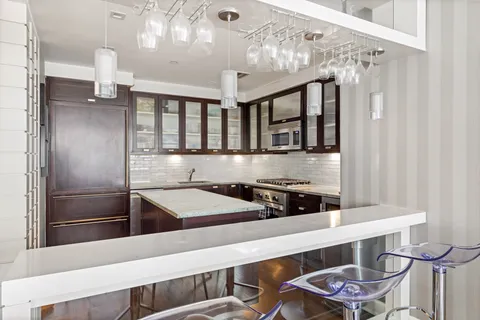 a kitchen with a table and chairs