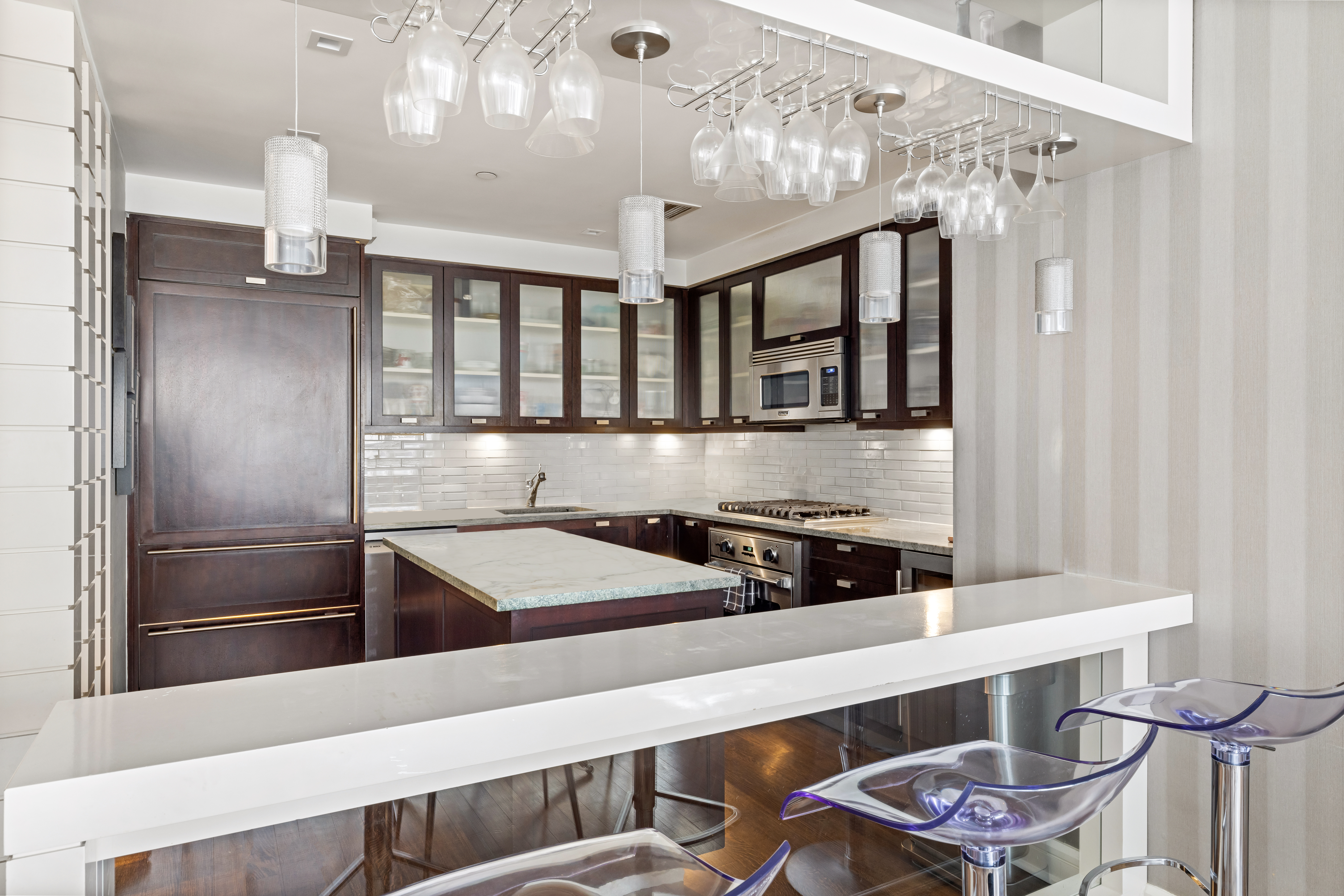 80 Riverside Boulevard, Unit 7E Manhattan, NY 10069 - Photo 5 of 12 a kitchen with a table and chairs