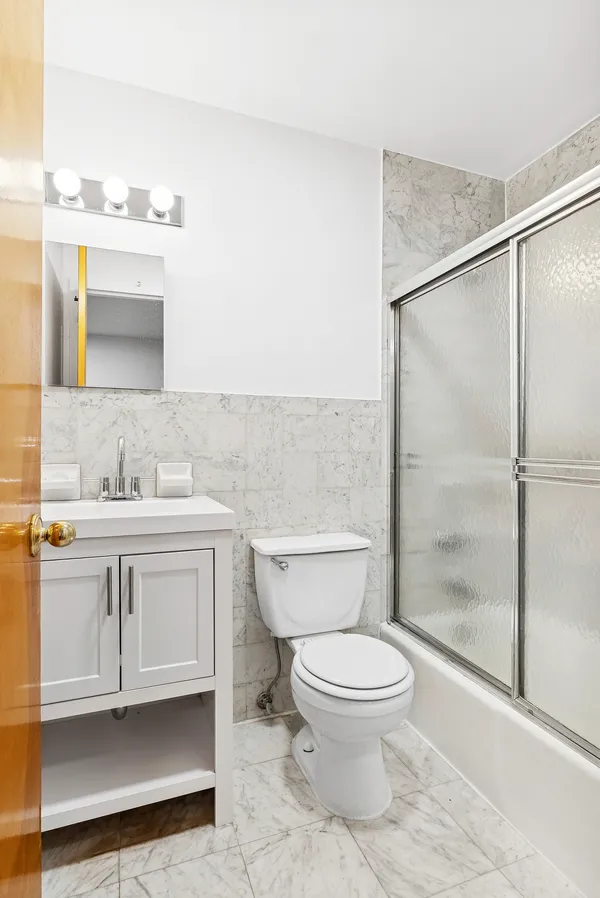 a bathroom with a toilet sink and a shower
