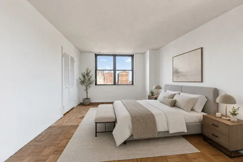 a bedroom with a large bed and a window