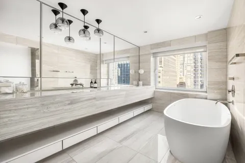 a spacious bathroom with a large tub and shower