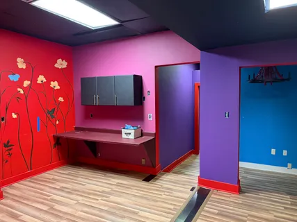 a view of a room with furniture and wooden floor