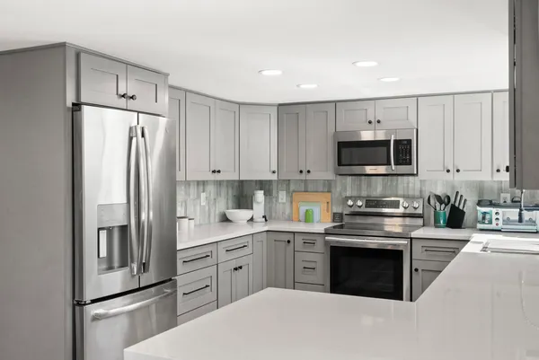 a kitchen with cabinets stainless steel appliances and a counter space