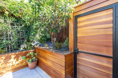 a backyard of a house with table and chairs