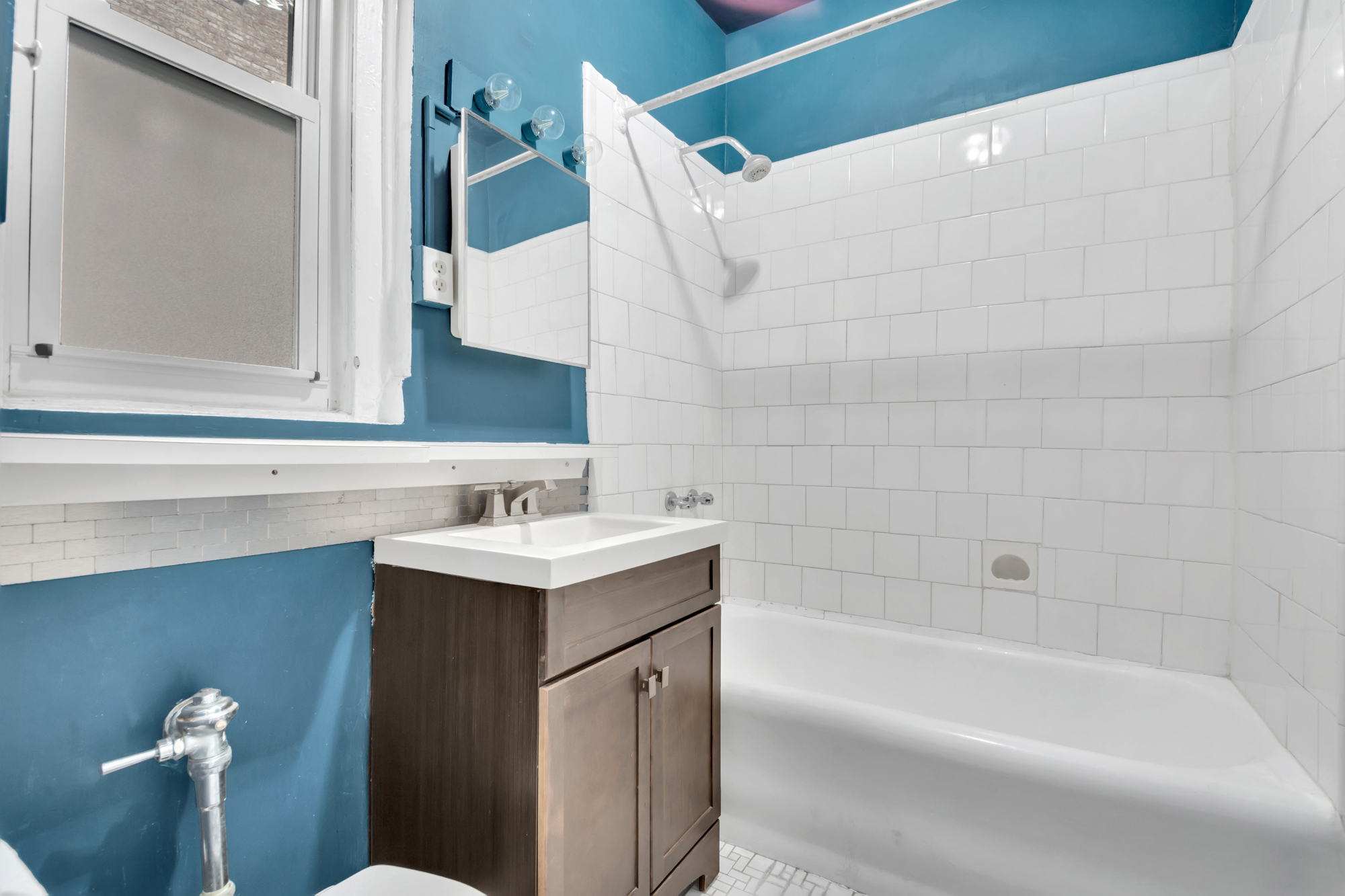 720 West 173rd Street, Unit 23 Manhattan, NY 10032 - Photo 9 of 10 a bathroom with a sink and a bathtub