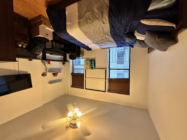 349 West 45th Street, Unit 3RE Manhattan, NY 10036 - Photo 4 of 5 a bedroom with a bed window and a chandelier
