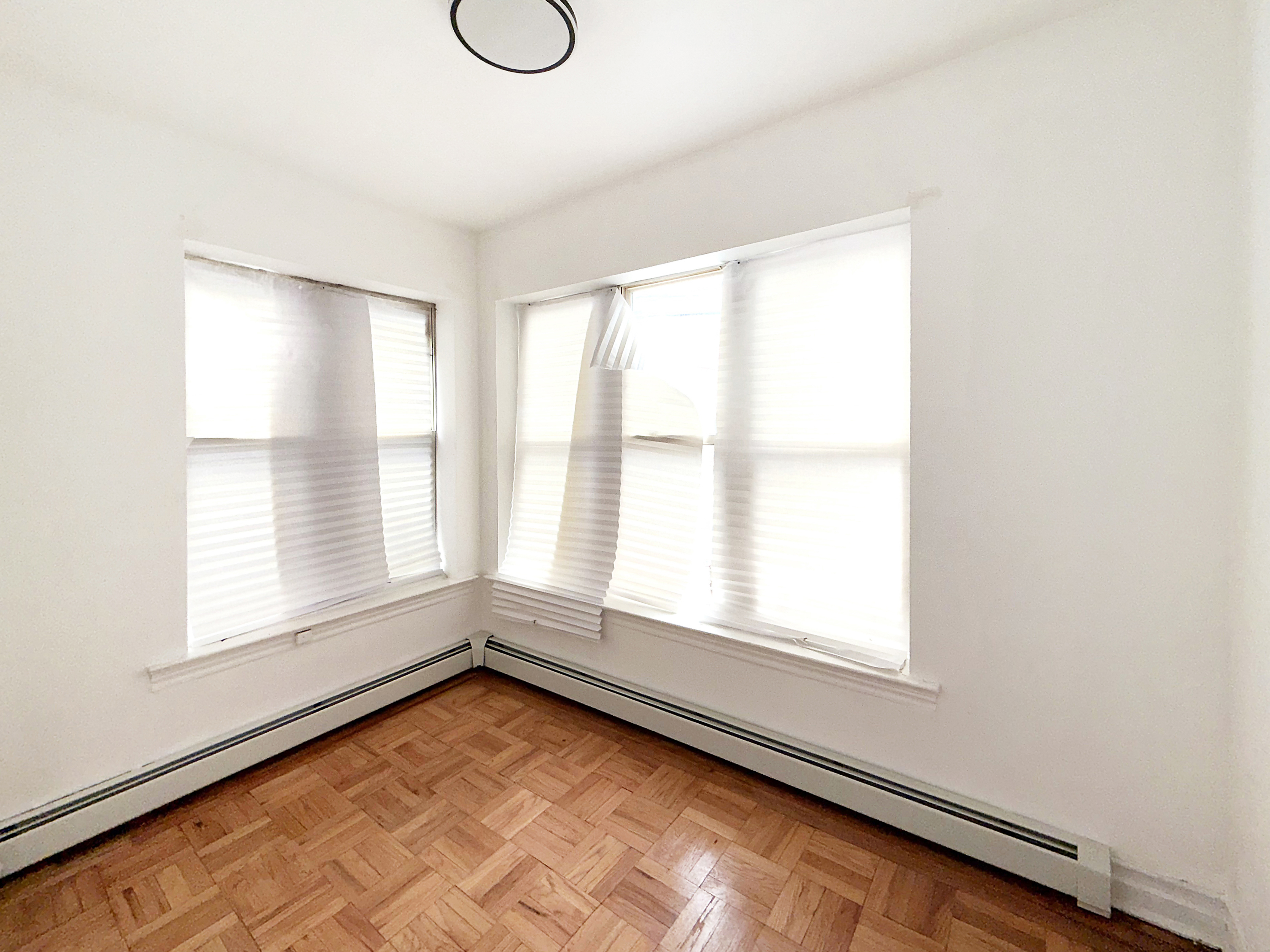 319 East 49th Street, Unit 1 Brooklyn, NY 11203 - Photo 5 of 8 a view of an empty room with a window