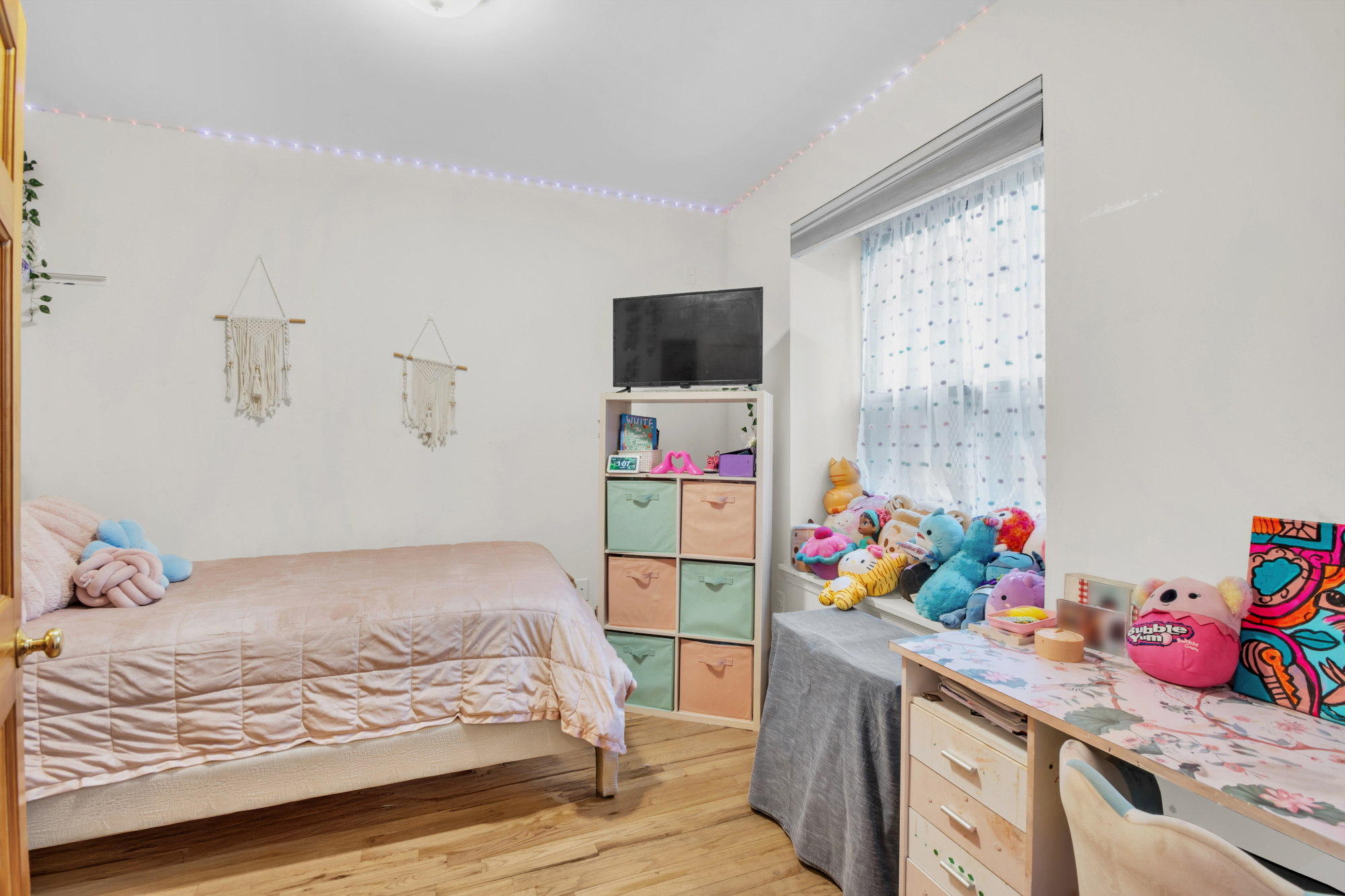 137 West 126th Street, Unit 1 Manhattan, NY 10027 - Photo 9 of 12 a bedroom with a bed table and a window