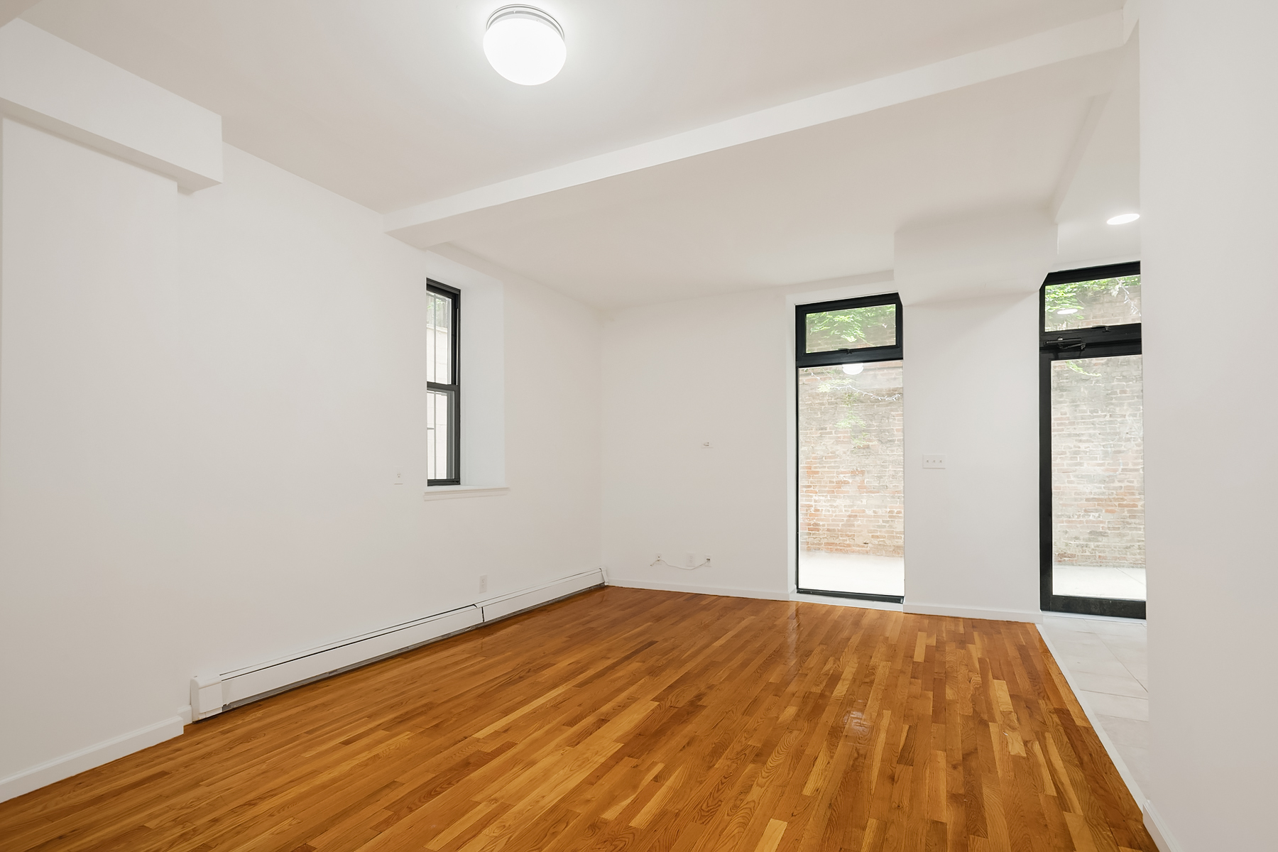 205 West 10th Street, Unit GARDEN Manhattan, NY 10014 - Photo 2 of 8 a view of empty room with wooden floor