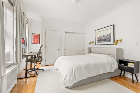 a bedroom with a bed and a table