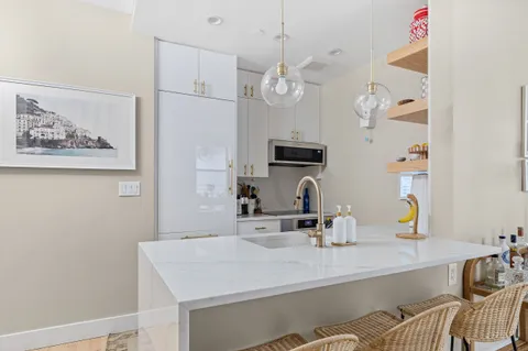a kitchen with cabinets a sink and stainless steel appliances