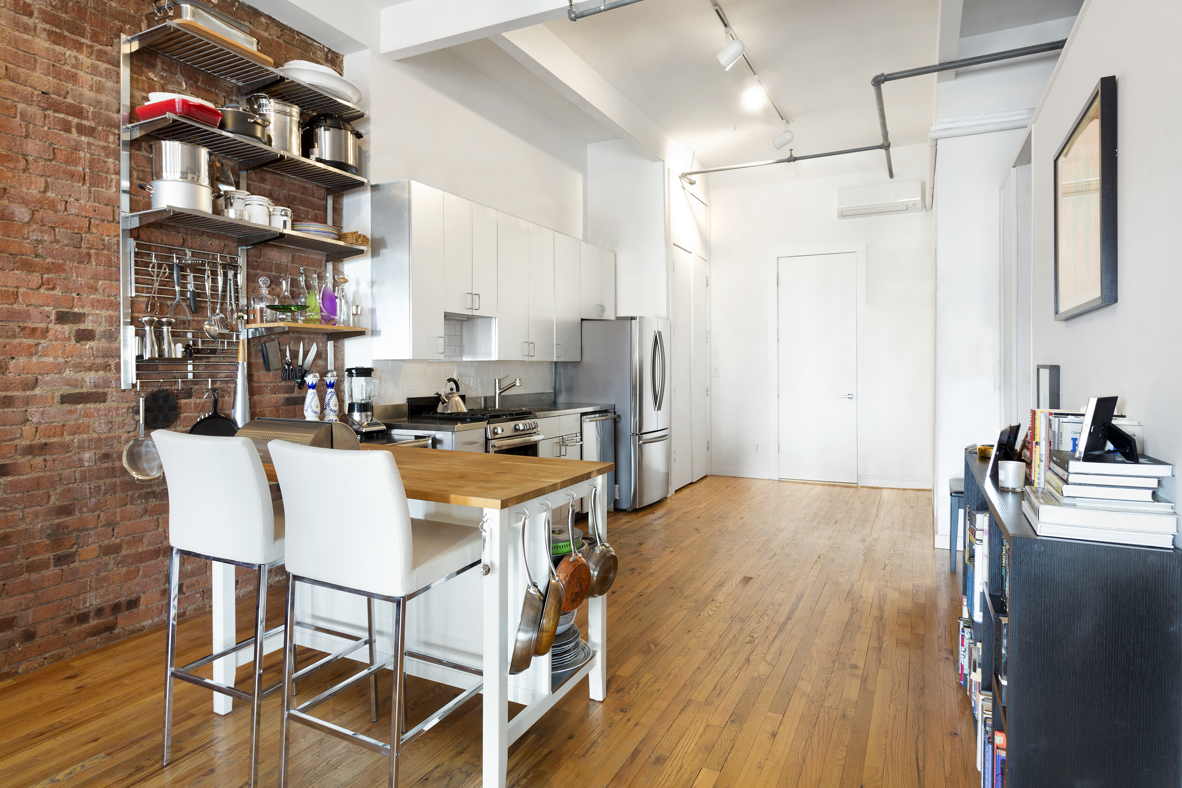 272 Water Street, Unit 5F Manhattan, NY 10038 - Photo 6 of 12 a kitchen with stainless steel appliances granite countertop a stove and a refrigerator