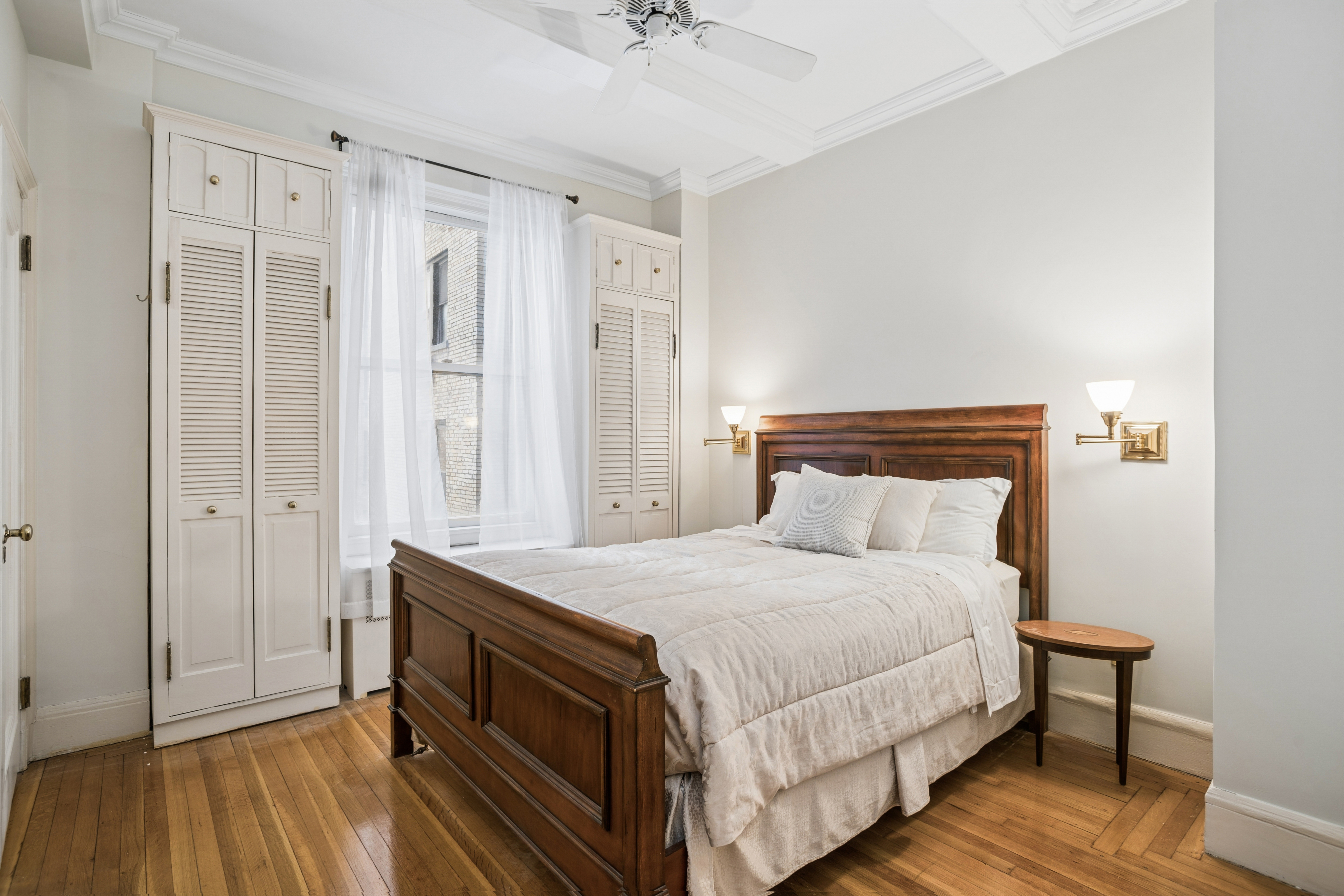 1060 Park Avenue, Unit 3A Manhattan, NY 10128 - Photo 4 of 11 a bedroom with a bed and a chandelier