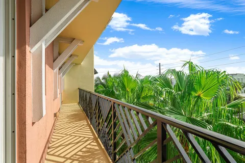 a view of a balcony with wooden floor