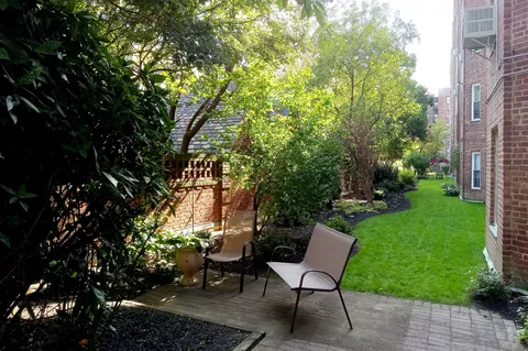 a view of a backyard with sitting area