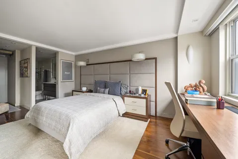 a bedroom with a bed a desk and chair