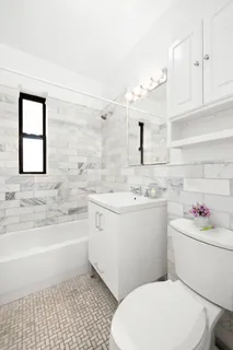 a bathroom with a sink toilet vanity and bathtub